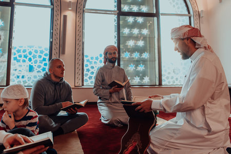 A group of Muslims reading the holy book of the Quran in a modern mosque during the Muslim holiday of Ramadanの写真素材