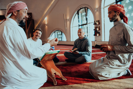 A group of Muslims reading the holy book of the Quran in a modern mosque during the Muslim holiday of Ramadanの写真素材