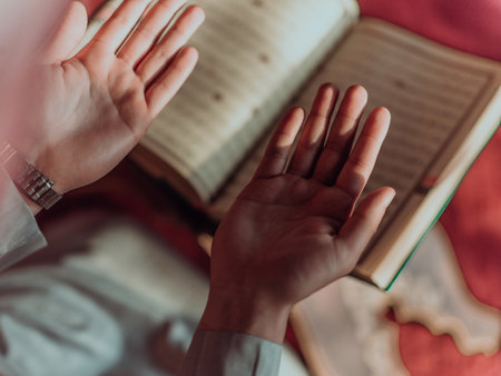 A Muslim reads the holy Islamic book Quraqn in a modern grand mosque during the Muslim holy month of Ranazanの写真素材