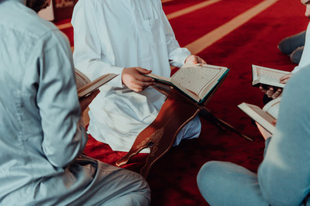 A group of Muslims reading the holy book of the Quran in a modern mosque during the Muslim holiday of Ramadanの写真素材