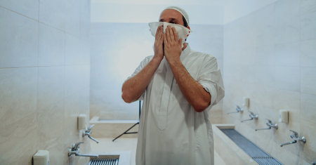 A portrait of a man in abdesthana using a towelの写真素材