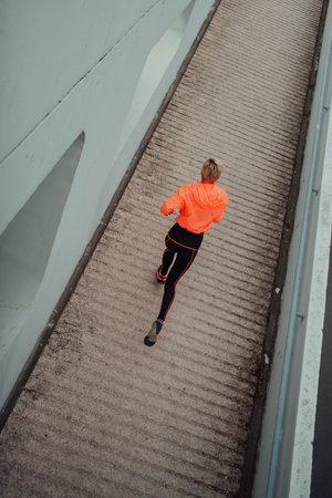 Top view photo of omen in sports clothes running in a modern urban environment. The concept of a...