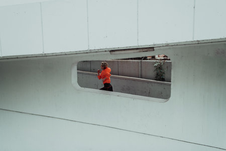 Women in sports clothes running in a modern urban environment. The concept of a sporty and healthy lifestyleの写真素材