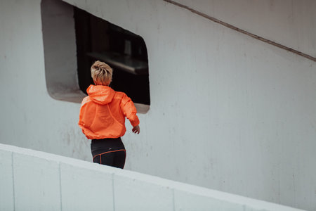 Women in sports clothes running in a modern urban environment. The concept of a sporty and healthy...