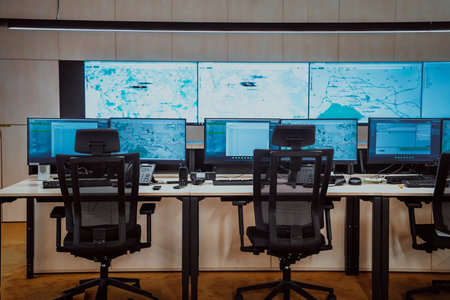 Empty interior of big modern security system control room, workstation with multiple displays,...