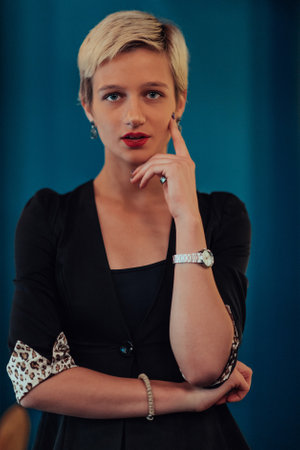 Blonde business woman, successful confidence on modern blue mat background. Selective focusの写真素材