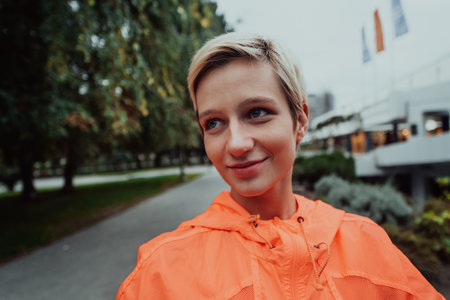 A blonde in a sports outfit is running around the city in an urban environment. The hot blonde...