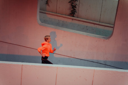 Women in sports clothes running in a modern urban environment et night time. The concept of a sporty and healthy lifestyleの写真素材