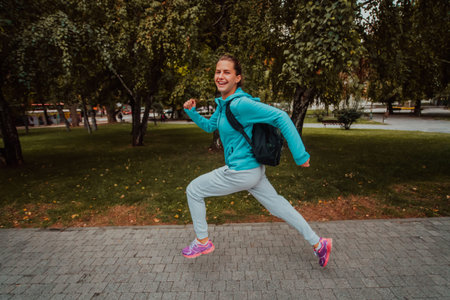 Women in sports clothes running in a modern urban environment. The concept of a sporty and healthy lifestyleの写真素材
