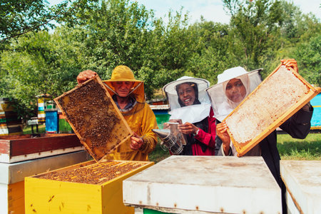 Arab investors checking the quality of honey on a large bee farm in which they have invested their...