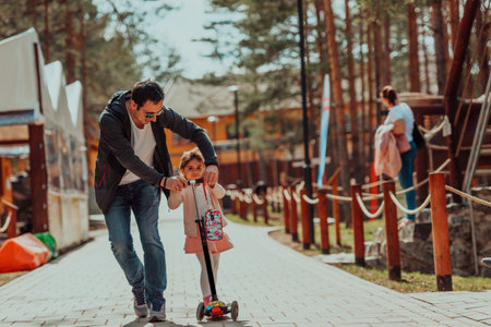 Family time in the park. Father have fun with his daughter in the park, playing fun games and spending time togetherの写真素材