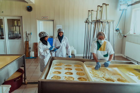 Arab business partners oversee cheese production in modern industryの写真素材