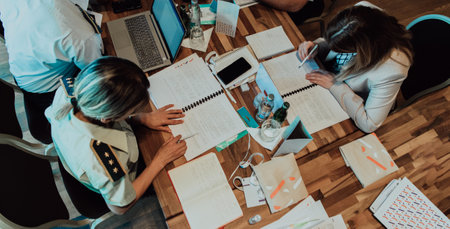 Top view of colleagues sorting out paperwork together. Businessman working with documentationの写真素材