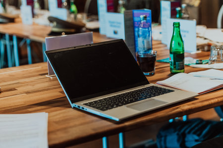 A laptop on the table of a large seminar hallの写真素材