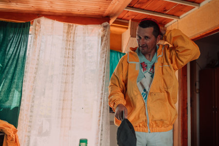 Beekeeper put on a protective beekeeping suit and preparing to enter the apiaryの写真素材