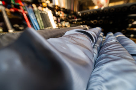 Collection of fashionable fabrics. Samples of different natural fabrics for sewing a fashion collection of clothes. Large selection of fabrics in the store or tailor warehouse.の写真素材