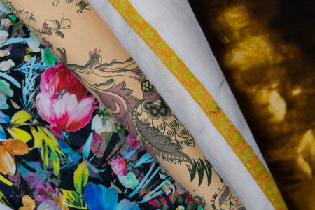 Collection of fashionable fabrics. Samples of different natural fabrics for sewing a fashion collection of clothes. Large selection of fabrics in the store or tailor warehouse.の写真素材