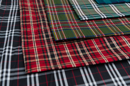 Collection of Scottish fashionable fabrics . Samples of different natural fabrics for sewing a fashion collection of clothes. Large selection of fabrics in the store or tailor warehouse.の写真素材
