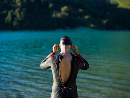 A triathlon swimmer preparing for a river training to gear up for a marathonの写真素材