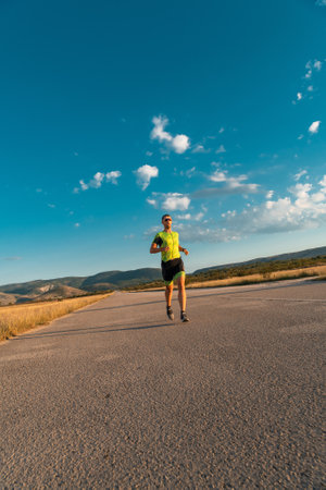Triathlete in professional gear running early in the morning, preparing for a marathon, dedication to sport and readiness to take on the challenges of a marathon.の写真素材