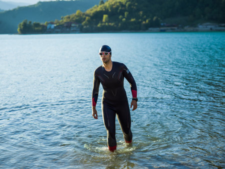 A triathlon swimmer preparing for a river training to gear up for a marathonの写真素材