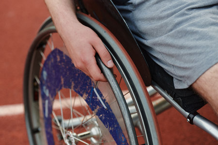 Close up photo of a person with disability in a wheelchair training tirelessly on the track in preparation for the Paralympic Gamesの写真素材