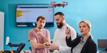 A group of students working together in a laboratory, dedicated to exploring the aerodynamic capabilities of a droneの写真素材
