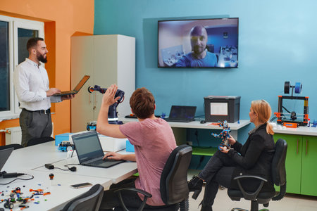 A group of colleagues working together in a robotics laboratory, focusing on the intricate fields of...