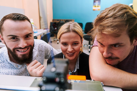 A group of colleagues working together in a robotics laboratory, focusing on the intricate fields of...