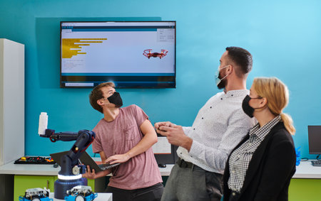A group of students working together in a laboratory, dedicated to exploring the aerodynamic capabilities of a droneの写真素材
