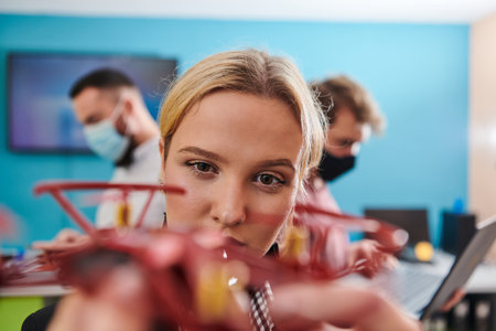 A group of students working together in a laboratory, dedicated to exploring the aerodynamic capabilities of a droneの写真素材