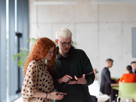 In a modern and spacious office a team of business colleagues are seen diligently working together,...