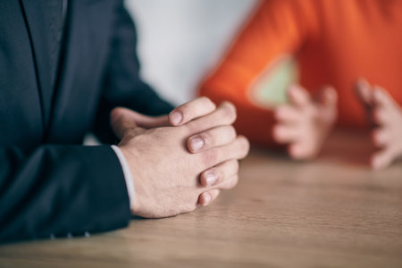 Closeup photo, the hands of businessmen sitting at a business meeting can be seen as they discuss...