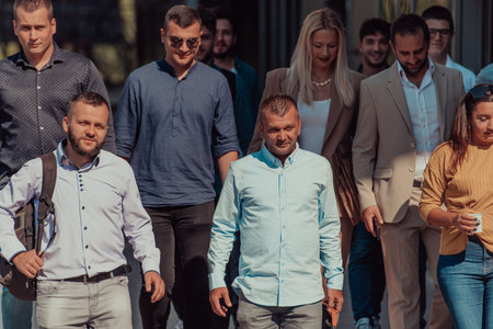 A diverse group of businessmen and colleagues walking together by their workplace, showcasing...