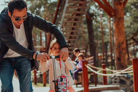 Family time in the park. Father have fun with his daughter in the park, playing fun games and spending time togetherの写真素材