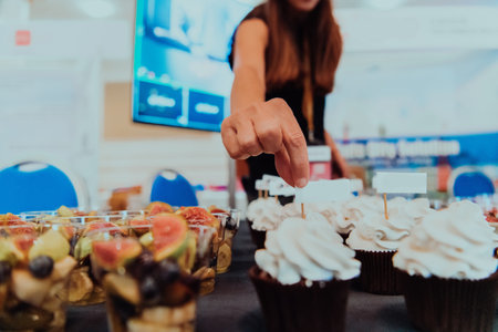 Business woman takes delicious food from the table while in the conference roomの写真素材