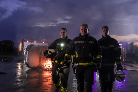Brave Firefighters Team Walking to the Camera. In Background Paramedics and Firemen Rescue Team...