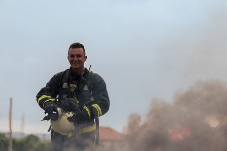 Portrait of a heroic fireman in a protective suit. Firefighter in fire fighting operation.