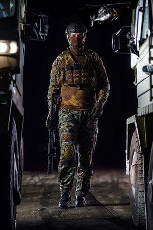 A soldier marching through the dark of night, accompanied by two military trucks, as he embarks on a...