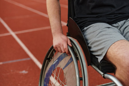 Close up photo of a person with disability in a wheelchair training tirelessly on the track in preparation for the Paralympic Gamesの写真素材
