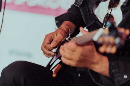 Practicing in playing guitar. Handsome young men playing guitar
