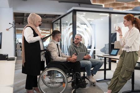 Young group of business people brainstorming together in a startup space, discussing business...