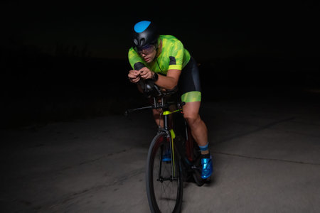 A triathlete rides his bike in the darkness of night, pushing himself to prepare for a marathon. The...