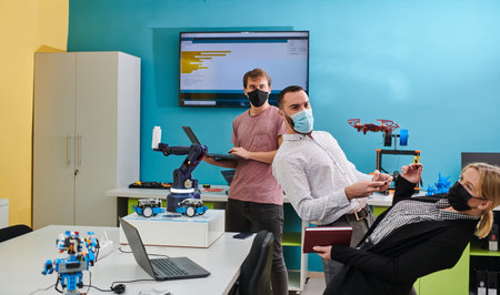 A group of students working together in a laboratory, dedicated to exploring the aerodynamic...