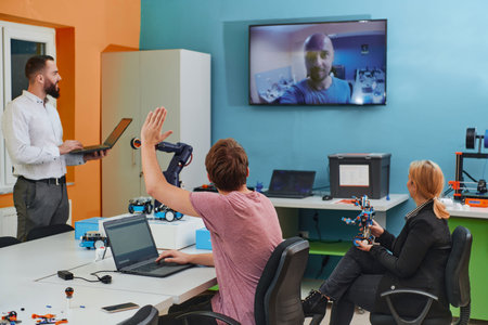 A group of colleagues working together in a robotics laboratory, focusing on the intricate fields of...