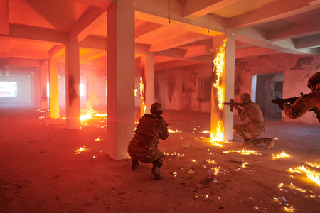 A group of professional soldiers bravely executes a dangerous rescue mission, surrounded by fire in a perilous building.の写真素材