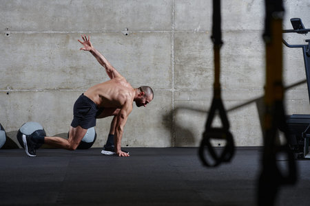 A muscular man standing in the starting position for running, exuding determination and readiness...