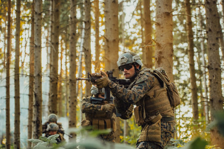 A group of modern warfare soldiers is fighting a war in dangerous remote forest areas. A group of soldiers is fighting on the enemy line with modern weapons. The concept of warfare and military conflictsの写真素材