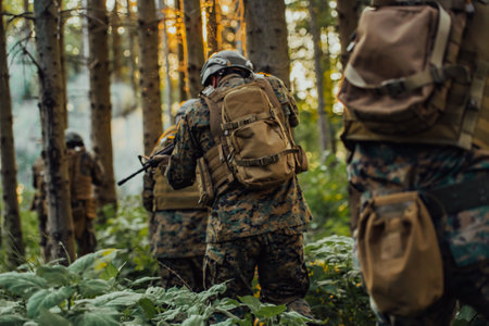 A group of modern warfare soldiers is fighting a war in dangerous remote forest areas. A group of soldiers is fighting on the enemy line with modern weapons. The concept of warfare and military conflictsの写真素材