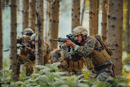 A group of modern warfare soldiers is fighting a war in dangerous remote forest areas. A group of soldiers is fighting on the enemy line with modern weapons. The concept of warfare and military conflictsの写真素材